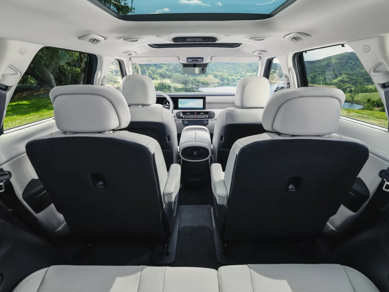 Interior of the Hyundai Palisade showing the 12.3-inch touchscreen and second-row seating